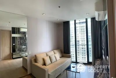 Modern living room with plush sofa, sleek glass coffee table, and floor-to-ceiling windows offering an urban view, accentuated by natural light.