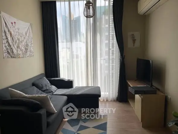 Modern living room with city view, stylish furniture, and natural light.