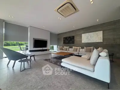 Luxurious modern living room with stylish furniture and large windows offering scenic views.