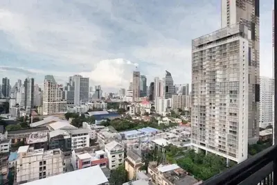 Stunning cityscape view from high-rise apartment balcony showcasing urban skyline.