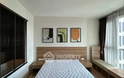 Modern bedroom with stylish decor and large window for natural light