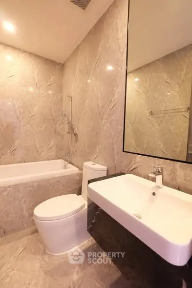 Luxurious marble bathroom with modern fixtures and bathtub