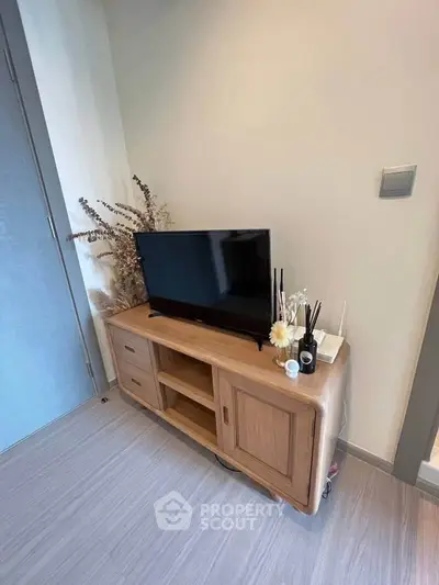 Modern living room corner with stylish wooden TV stand and decor