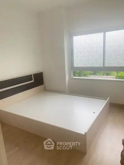 Minimalist bedroom with modern bed frame and large window