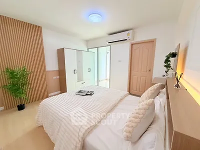 Modern bedroom with stylish decor and ample natural light