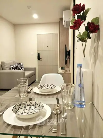Modern living room with elegant dining setup and cozy seating area, perfect for urban living.