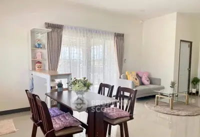 Charming open-plan living room with cozy dining area and plush seating.