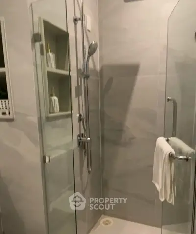 Modern bathroom with glass shower enclosure and sleek fixtures