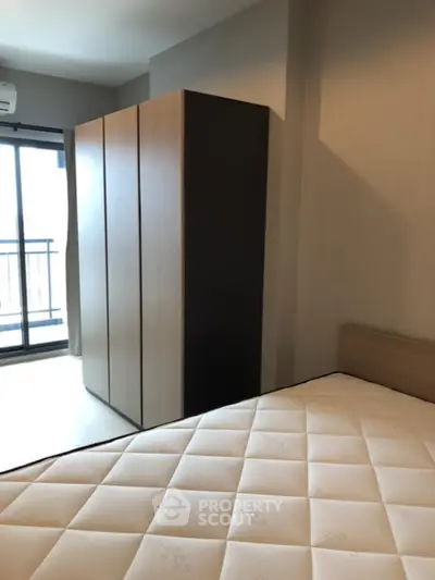 Modern bedroom with large wardrobe and balcony access