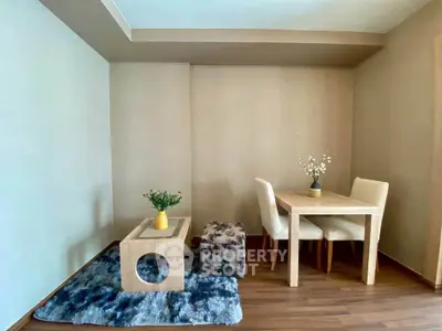 Cozy dining area with modern furniture and stylish decor in a well-lit room.
