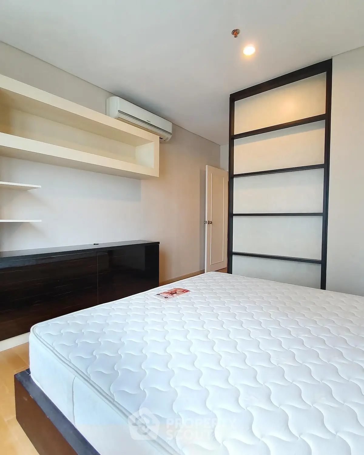 Spacious bedroom with modern design and ample storage space