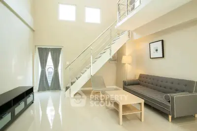 Spacious modern living room with high ceiling and stylish furniture