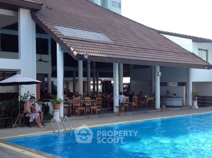 Luxurious poolside view with elegant seating area and modern architecture.