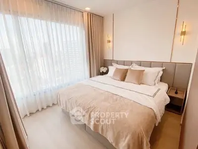 Luxurious bedroom with large window and elegant decor in modern apartment