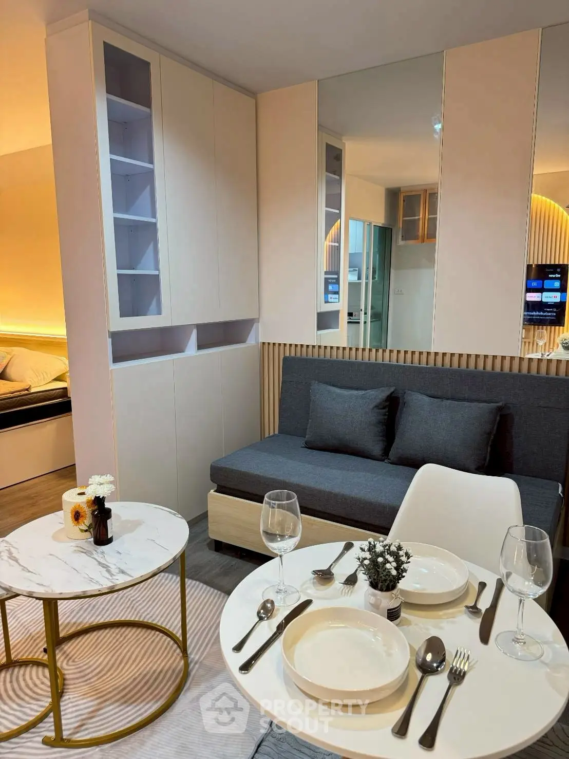 Modern living room with stylish dining area and cozy seating, perfect for urban living.