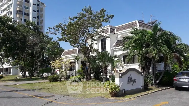 Charming residential building with lush greenery and modern architecture in a serene neighborhood.