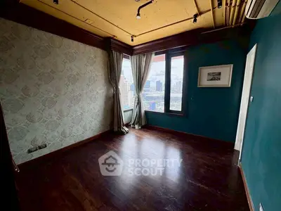 Spacious corner unit with city view and elegant decor in high-rise building.