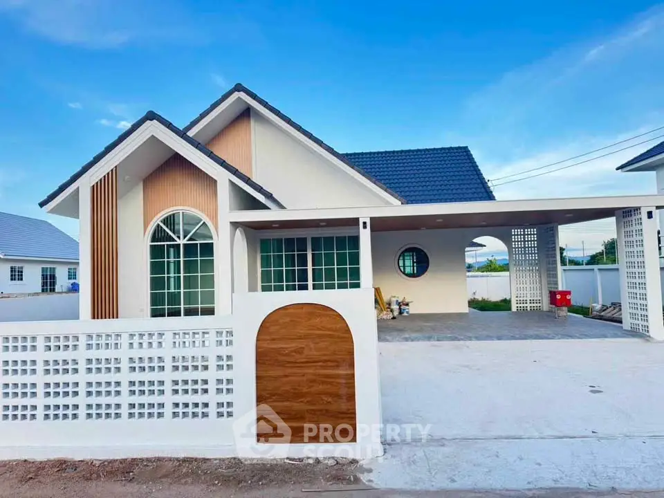 Charming modern house with unique architectural design and spacious driveway in a serene neighborhood.