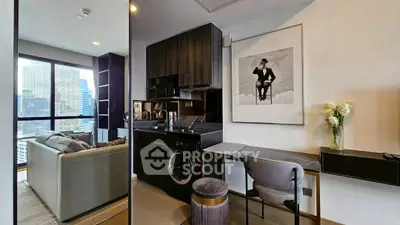 Modern studio apartment with city view, stylish decor, and compact kitchen featuring washing machine.