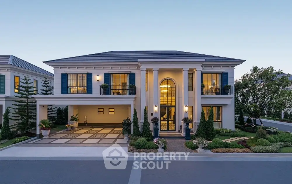 Luxurious two-story mansion with elegant columns and landscaped garden