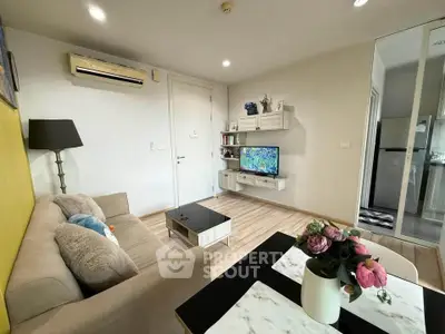 Modern living room with stylish decor and cozy ambiance, featuring a wall-mounted TV and elegant furnishings.