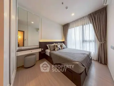 Modern bedroom with large windows and stylish decor, featuring a cozy bed and elegant furnishings.
