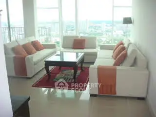 Spacious living room with modern furniture and panoramic city views.