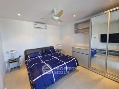 Modern bedroom with sleek design and mirrored wardrobe