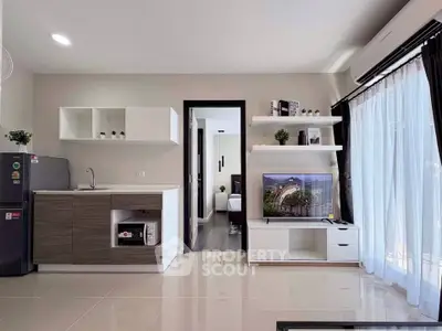 Modern open-layout living room with sleek kitchen and natural light