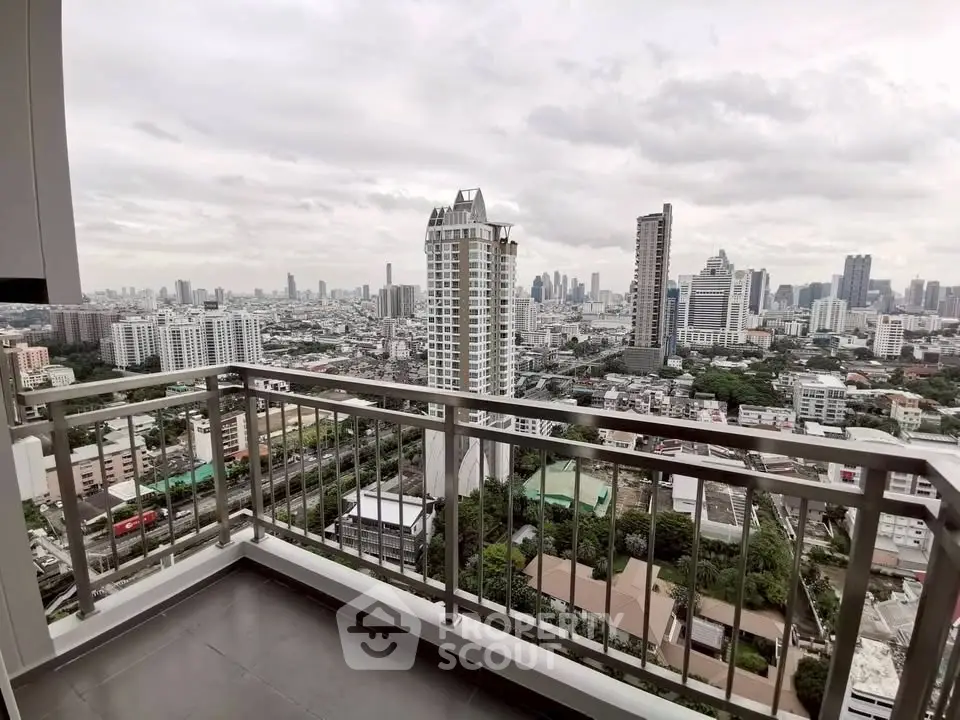 Stunning cityscape view from high-rise balcony in urban setting.
