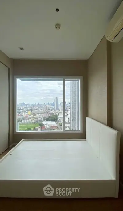 Spacious bedroom with stunning city view from large window