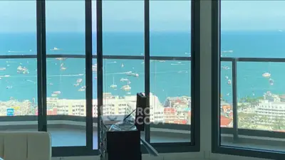 Stunning ocean view from high-rise apartment with floor-to-ceiling windows