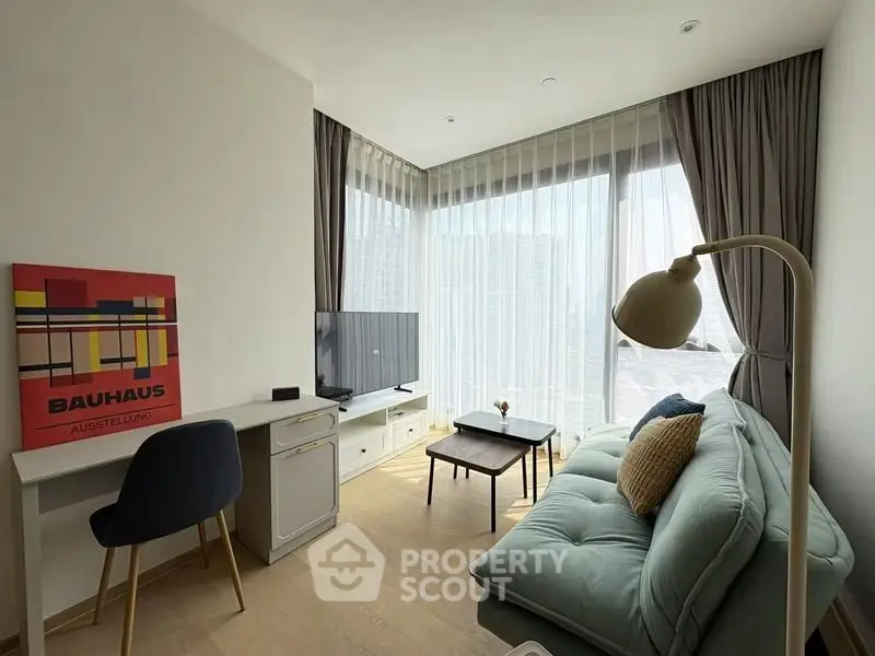 Modern living room with stylish decor, large windows, and cozy seating area.