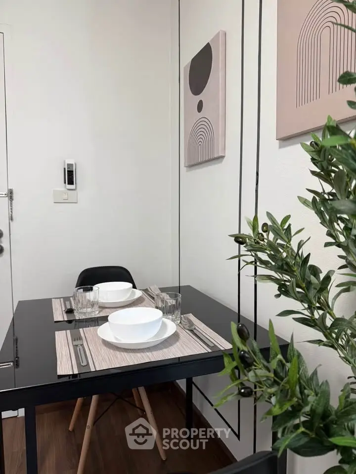 Modern dining area with sleek black table and stylish decor