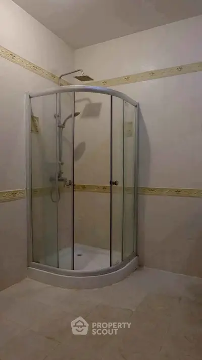 Modern bathroom with glass shower enclosure and elegant tile design.