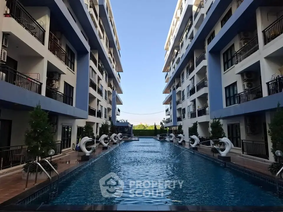 Luxurious apartment complex with stunning central swimming pool and modern architecture.