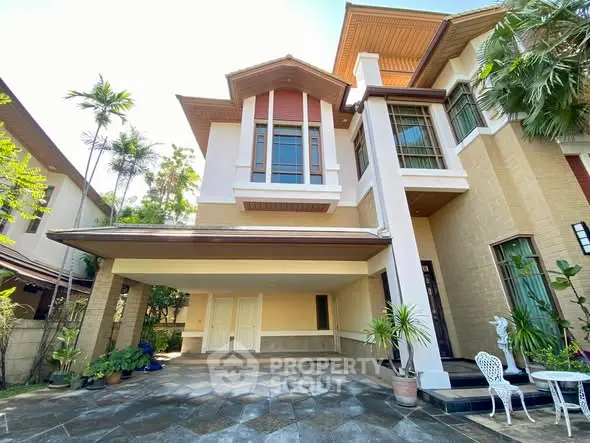 Stunning two-story house with spacious driveway and lush greenery