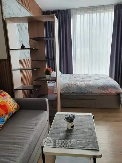 Modern studio apartment with cozy living area and stylish bedroom