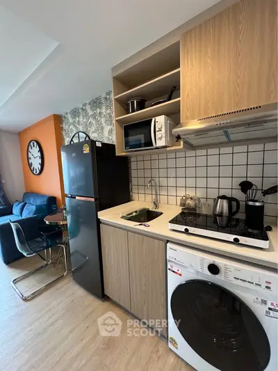 Modern kitchen with sleek appliances and open layout in stylish apartment