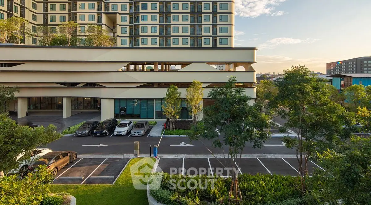 Modern apartment building with lush greenery and spacious parking area