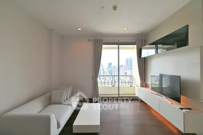 Modern living room with city view, sleek furniture, and large windows in a high-rise apartment.