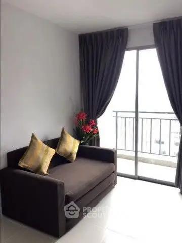 Cozy living room with sofa and balcony view in modern apartment