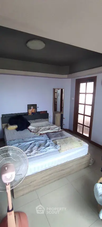 Spacious bedroom with modern decor and natural light