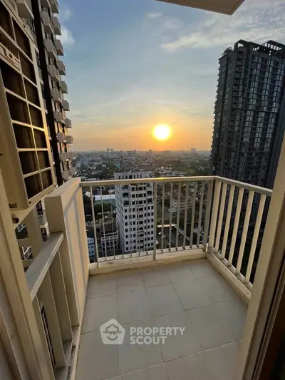 Stunning high-rise balcony with breathtaking sunset city view, perfect for urban living enthusiasts.