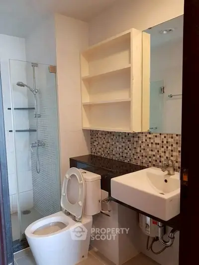 Modern bathroom with sleek fixtures and mosaic tile accents