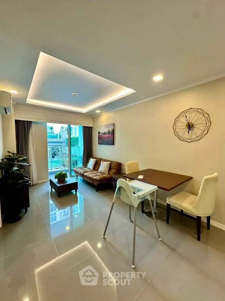 Modern living room with sleek design and balcony view in upscale apartment.