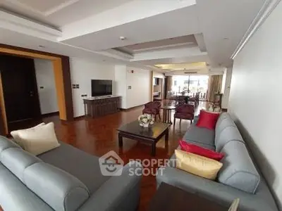 Spacious living room with elegant decor and ample natural light, perfect for relaxation and entertainment.