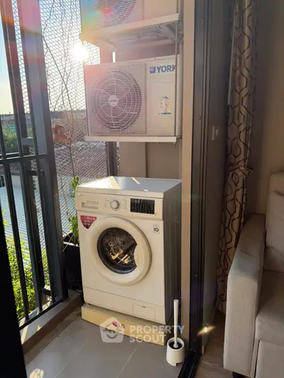 Charming balcony with washing machine and air conditioning unit, perfect for urban living convenience.