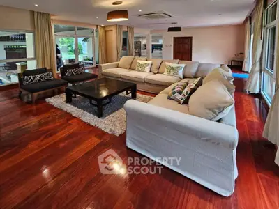 Spacious living room with elegant hardwood floors and plush seating in a modern home.