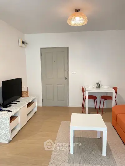 Cozy living room with modern decor and dining area, perfect for relaxation.